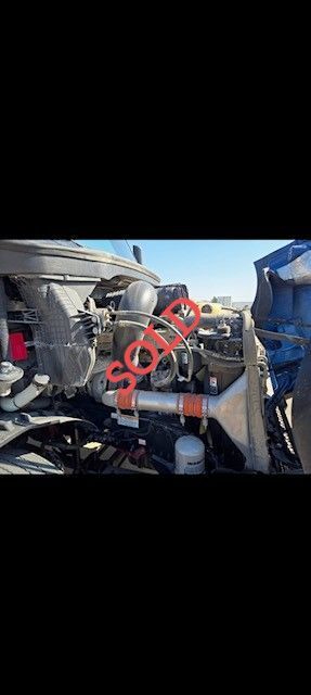 Engine bay of a blue semi-truck with a red 