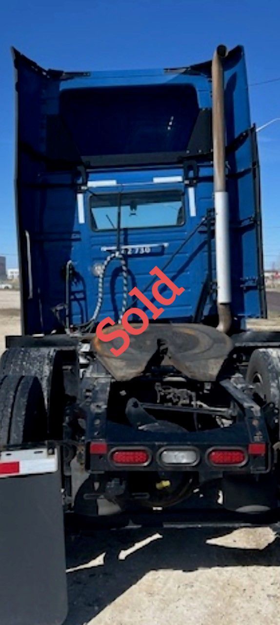 Rear view of a blue semi-truck with a 