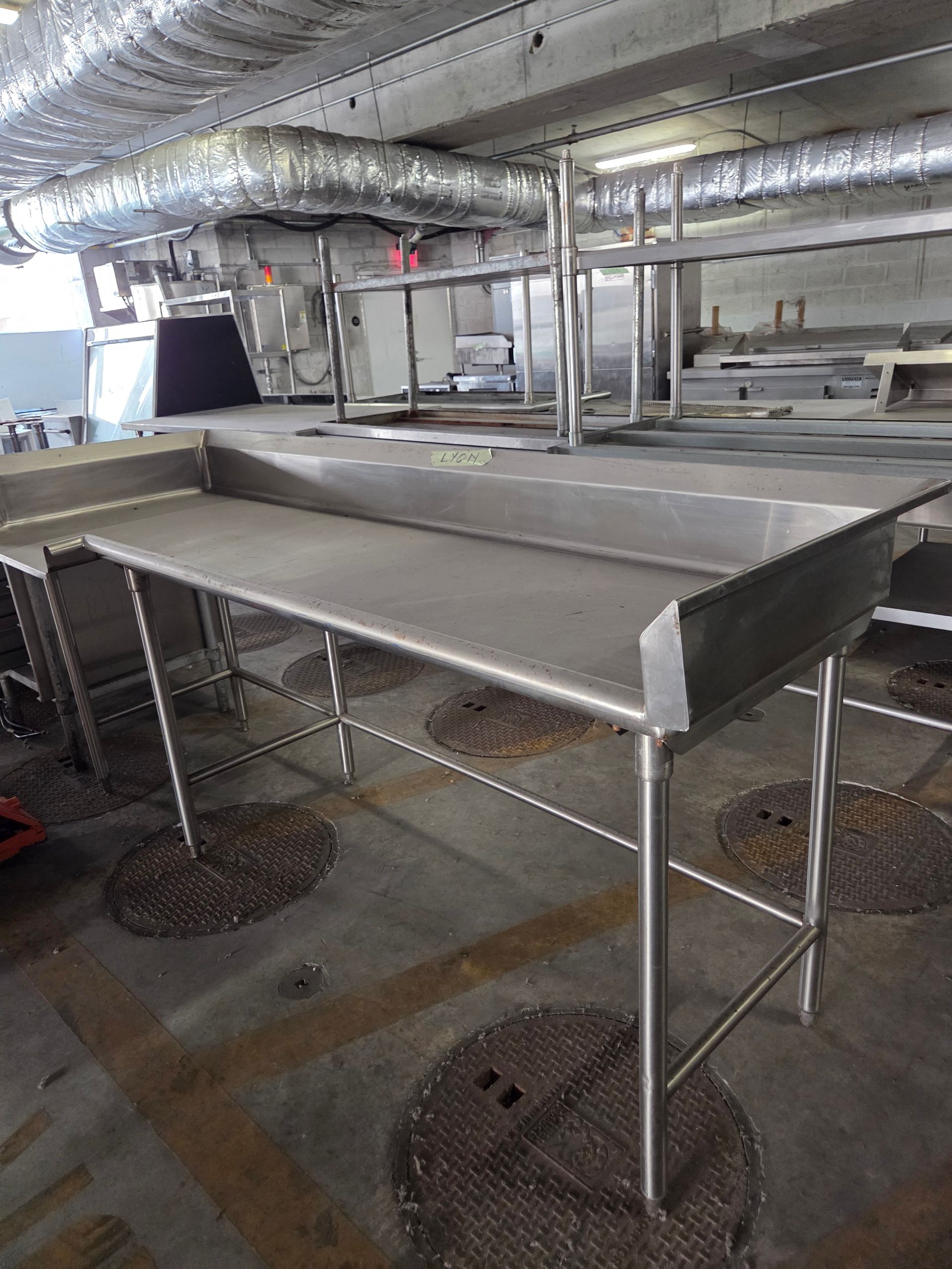 Stainless steel work tables in a commercial kitchen.