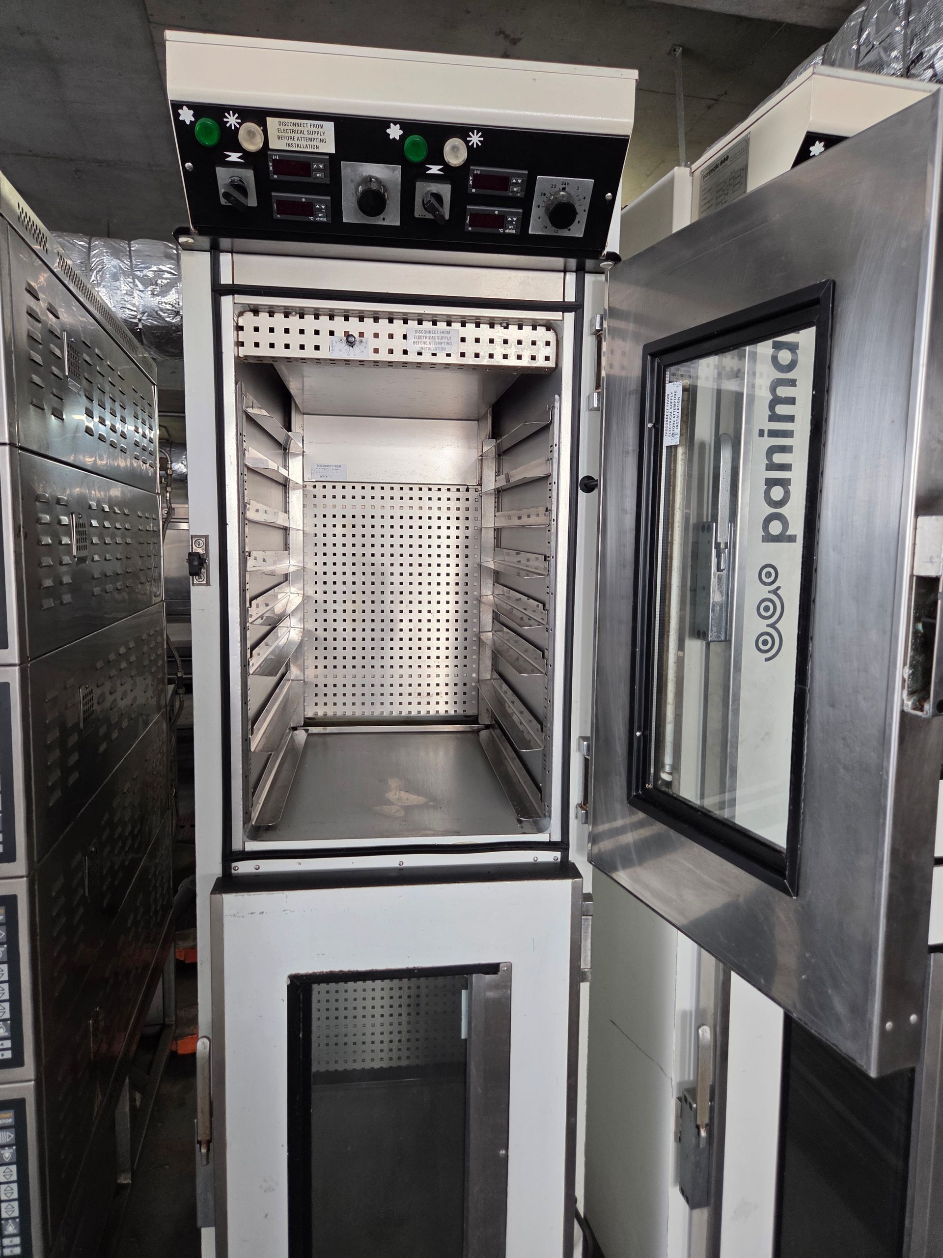 A commercial oven with an open door, stainless steel interior, and control panel at the top.