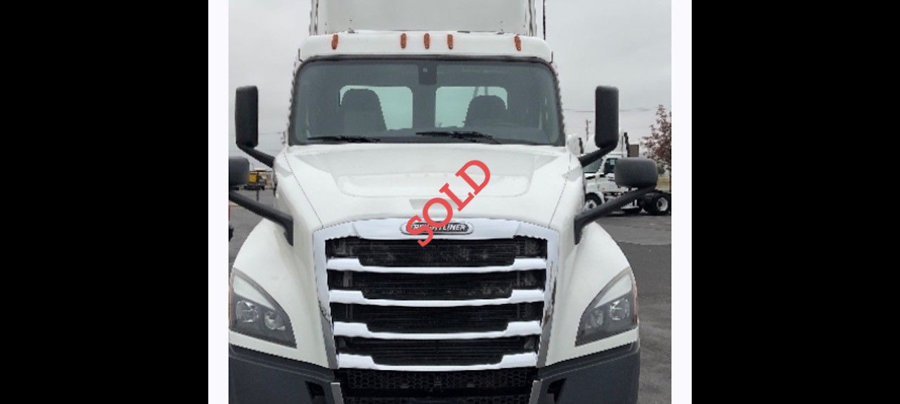 White Freightliner semi-truck with 