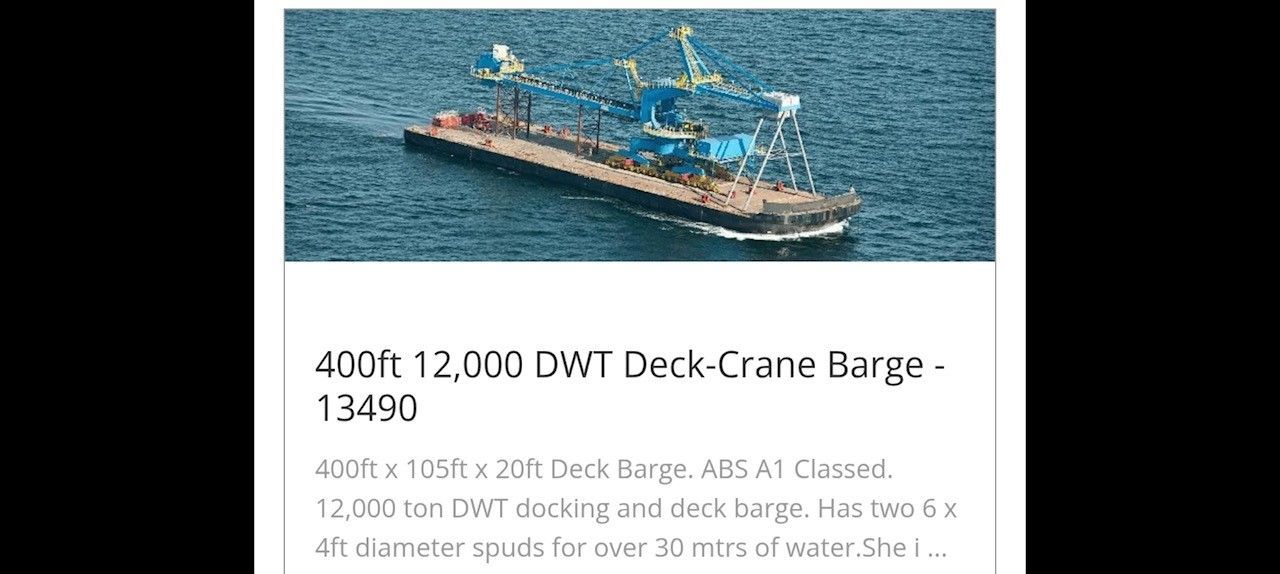 Deck-crane barge on the ocean, with cranes at the front and a long deck.