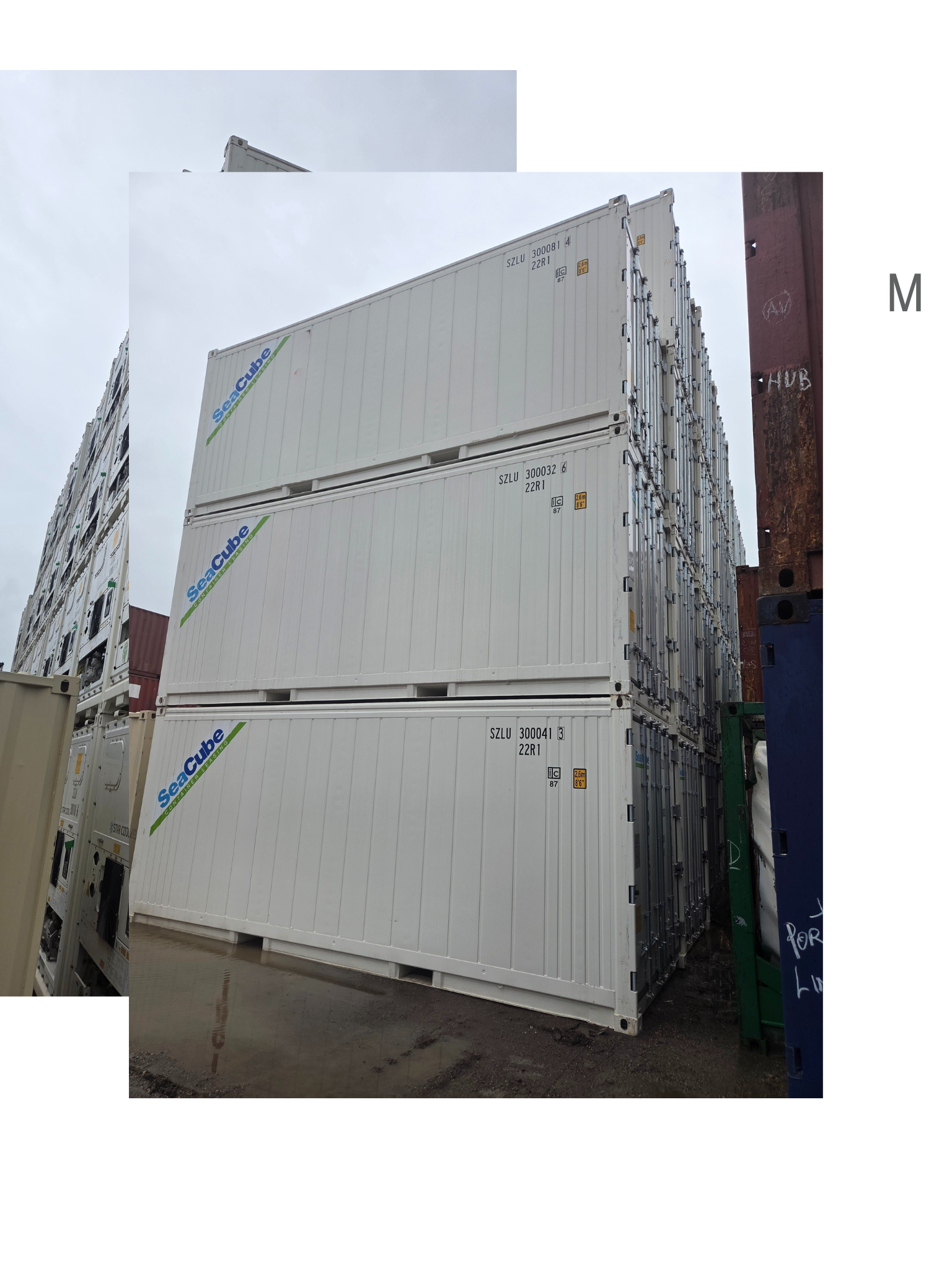 Three stacked white shipping containers.