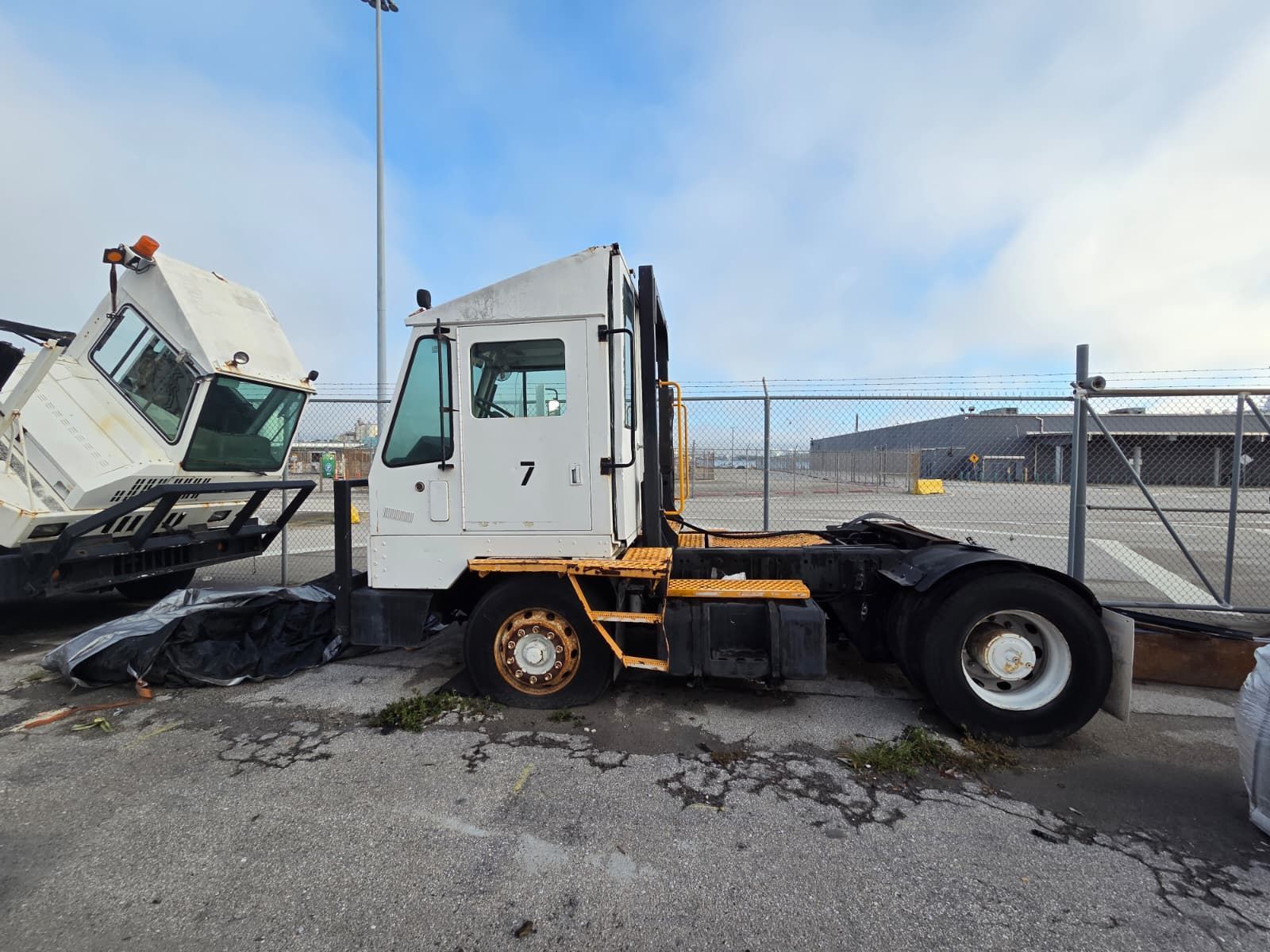White and yellow industrial truck labeled 