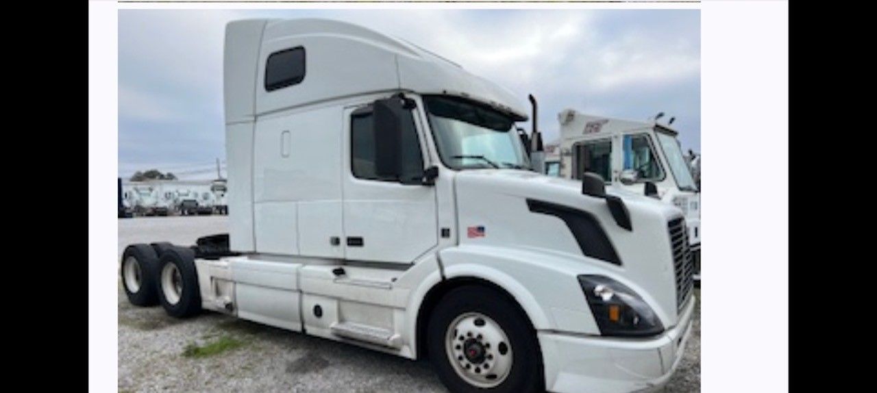 White semi-truck parked outdoors.