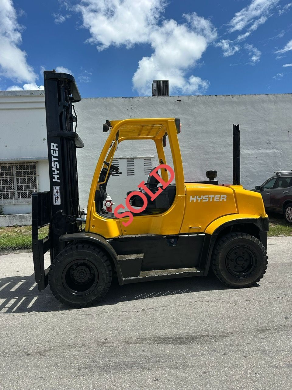 Yellow Hyster forklift on pavement with 