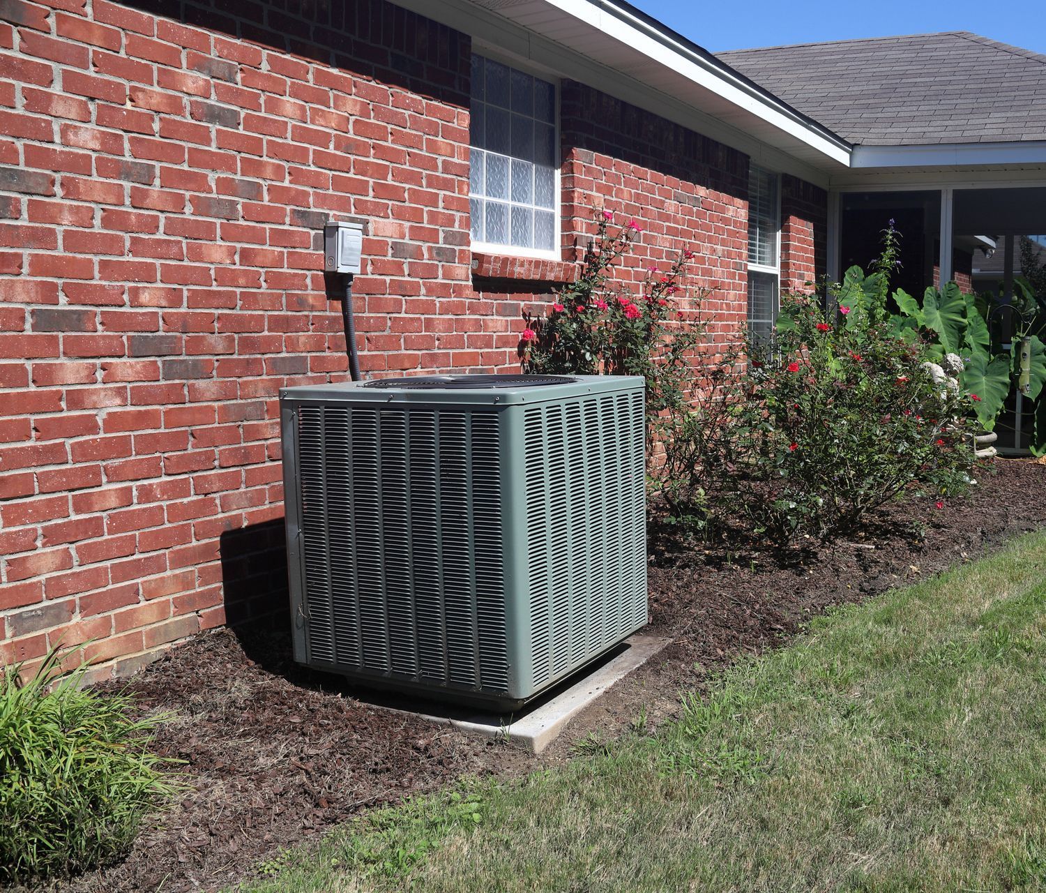A brick house with an air conditioner on the side of it