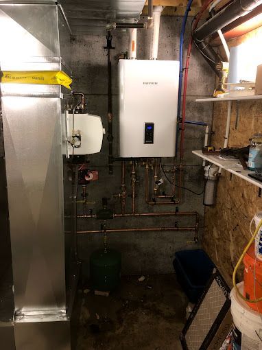 There is a water heater in the corner of the room.
