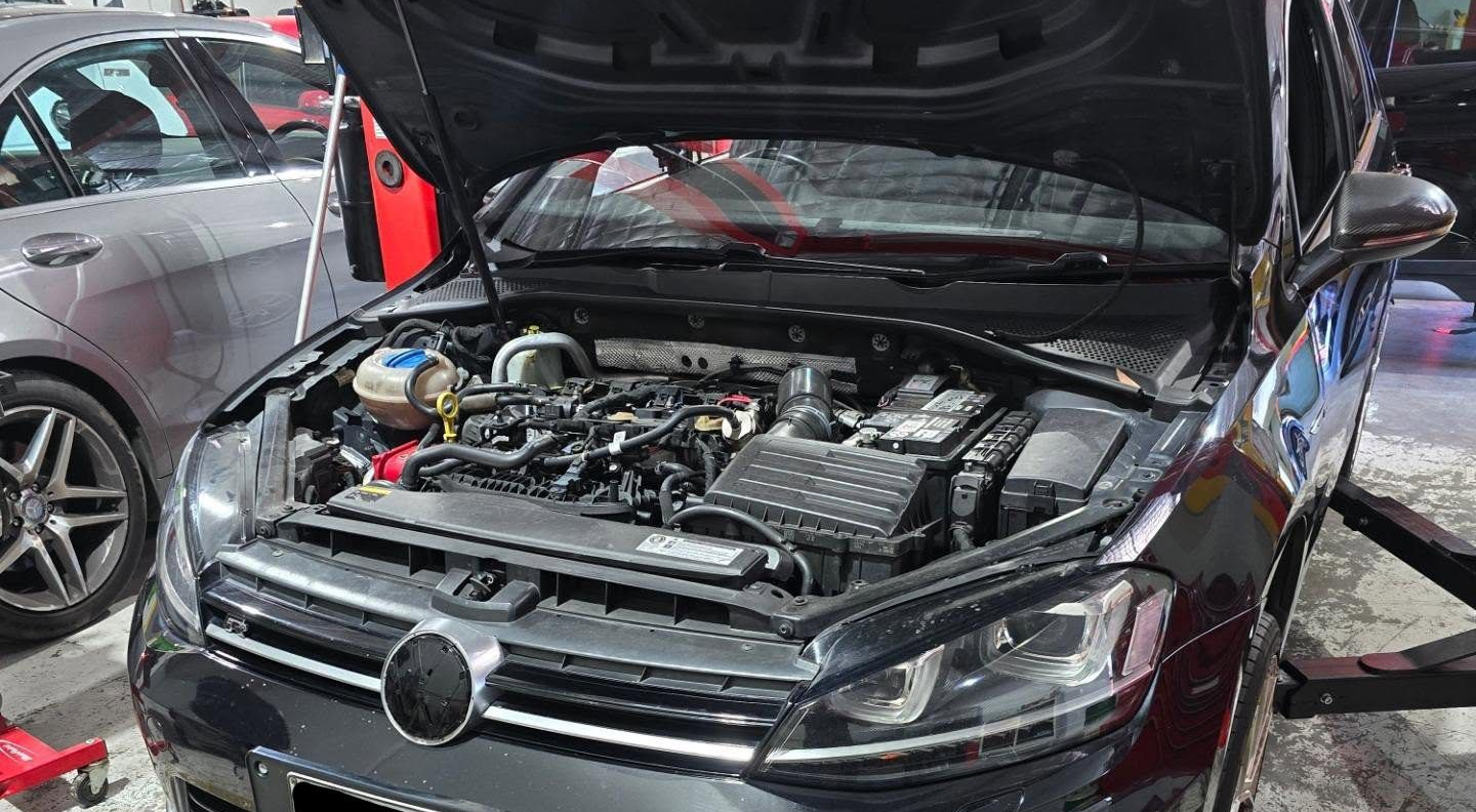 Black car with its hood open, revealing the engine in a garage — MC Automotive Service & Repairs in Maitland, NSW