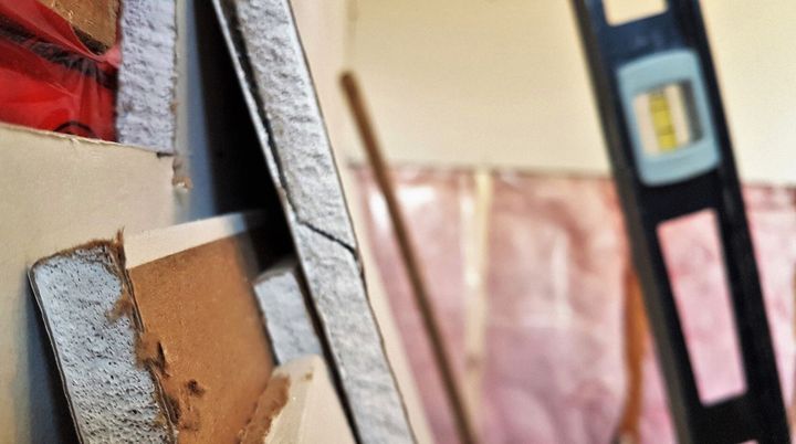 Drywall supplies stacked on wall