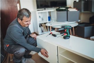 Handyman assembling furniture