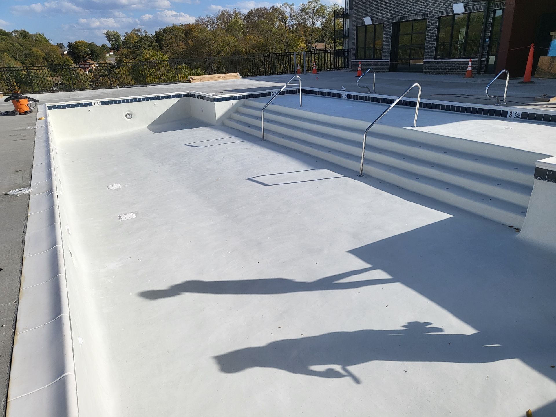 A large swimming pool is being built on the roof of a building.