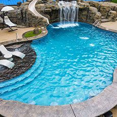 There is a waterfall in the middle of the pool.