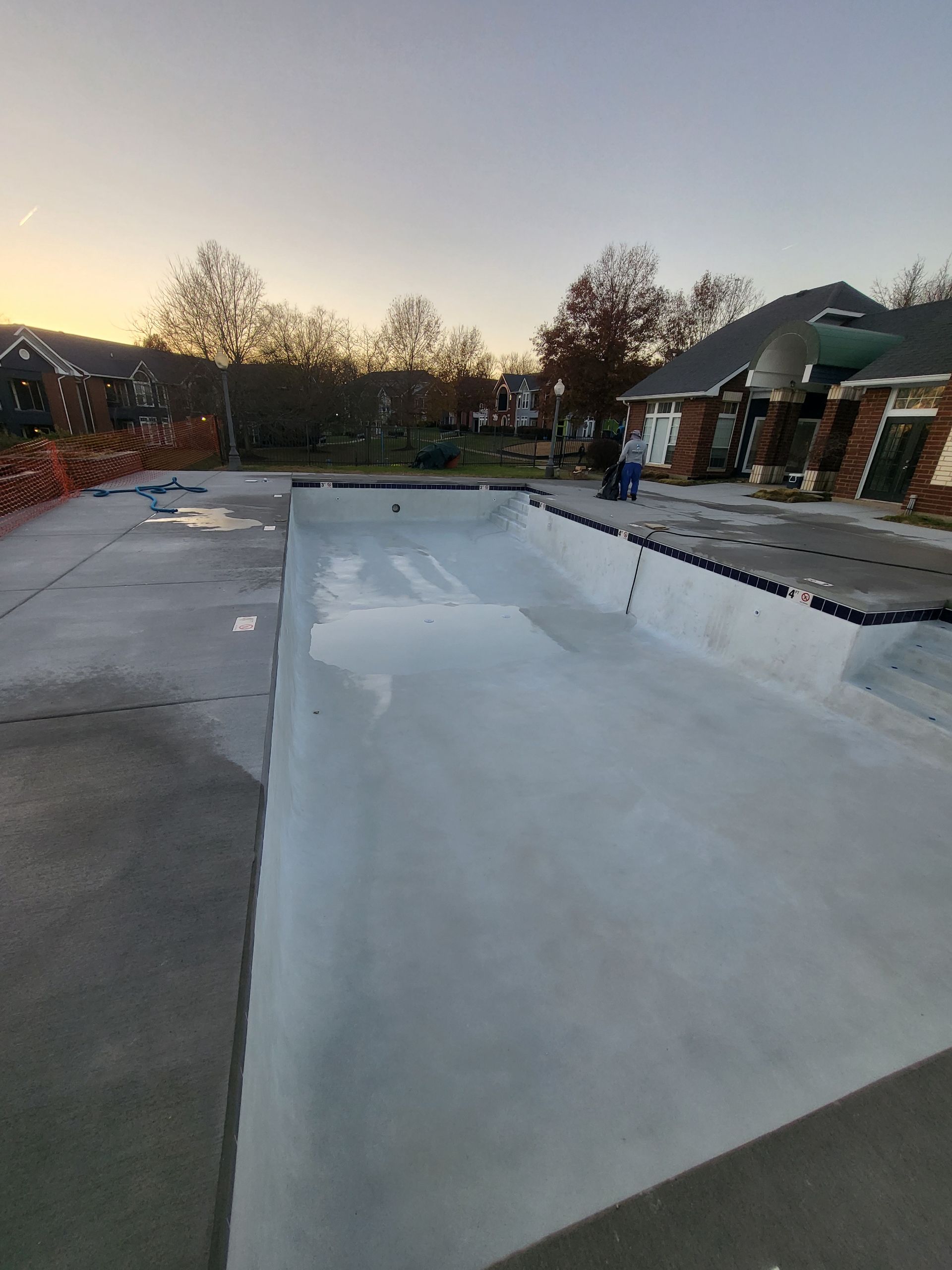 A swimming pool is being built in front of a house