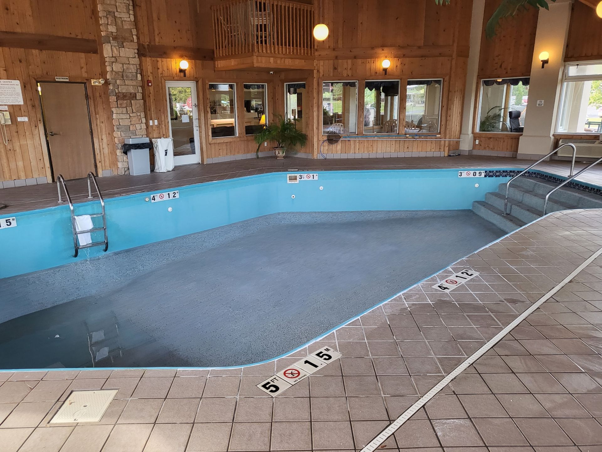 A large indoor swimming pool with stairs leading to it