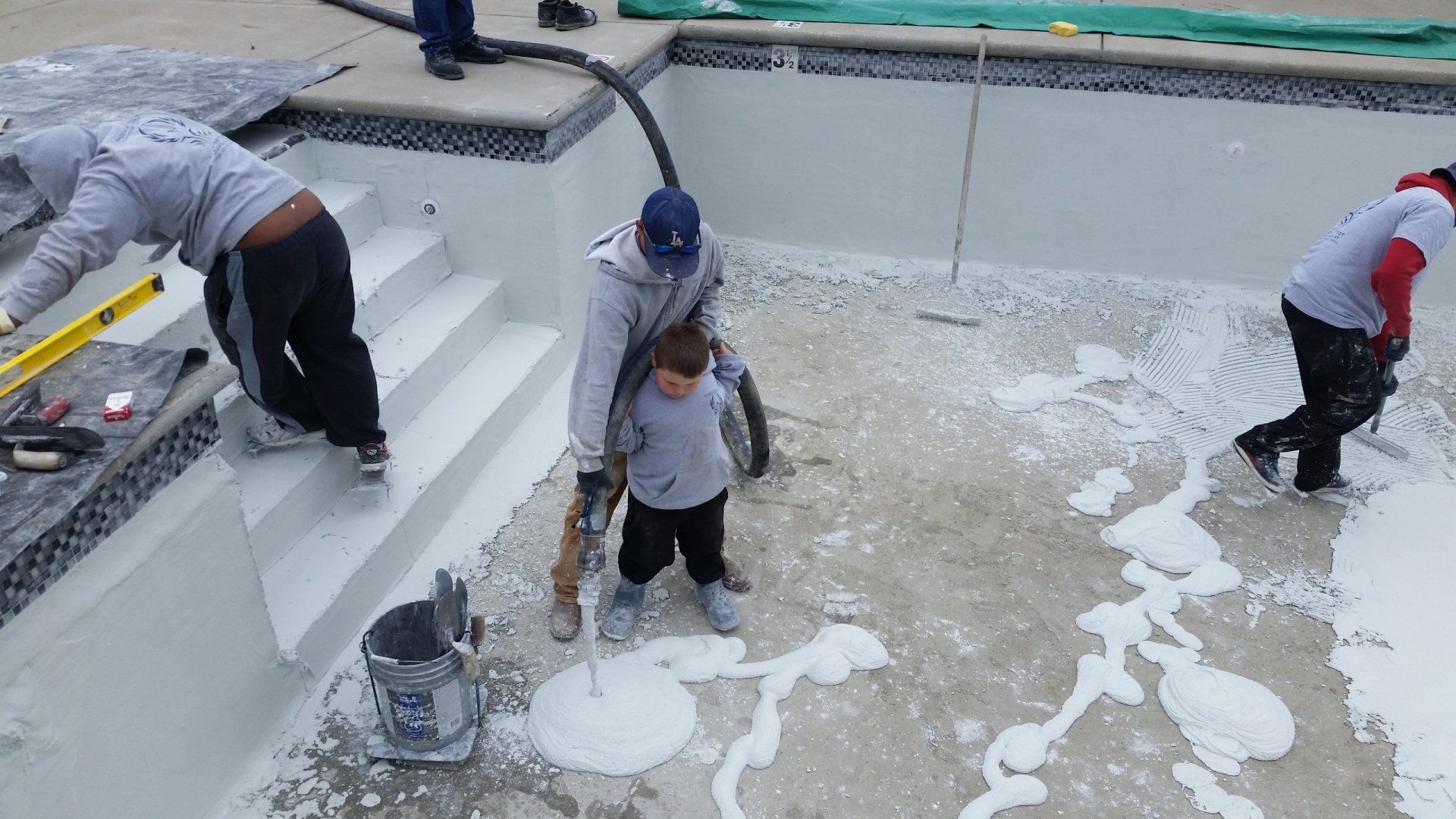 A group of people are working on a swimming pool.