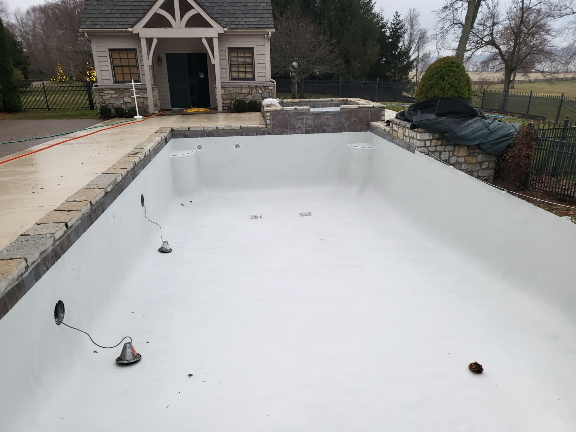 A swimming pool is being built in front of a house.