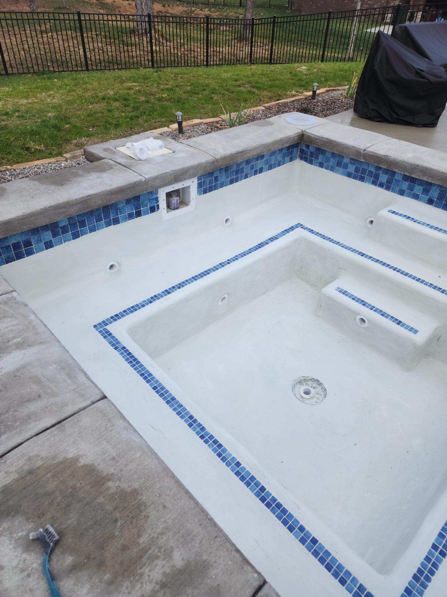 A swimming pool with a hose attached to it