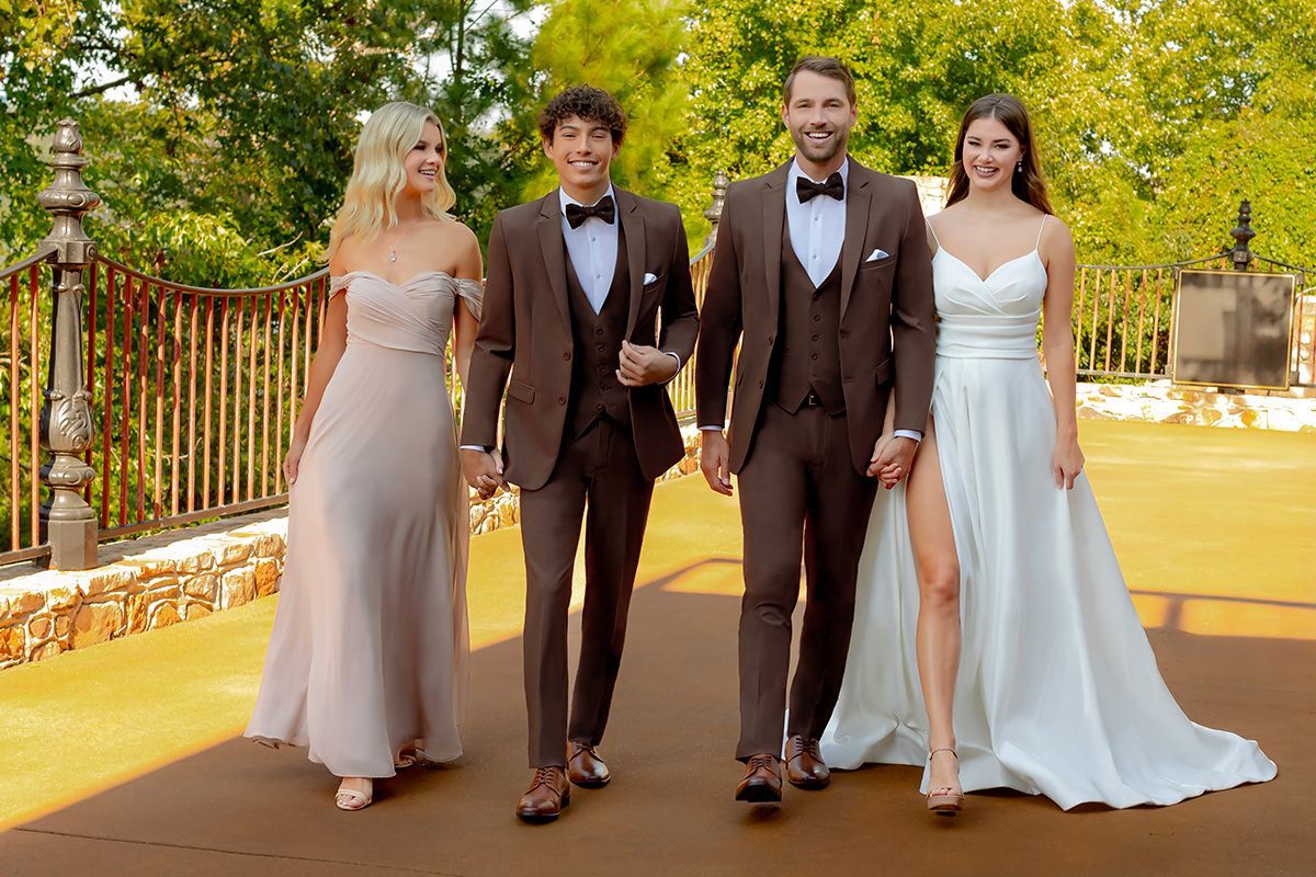 A group of people standing next to each other on a dirt road.