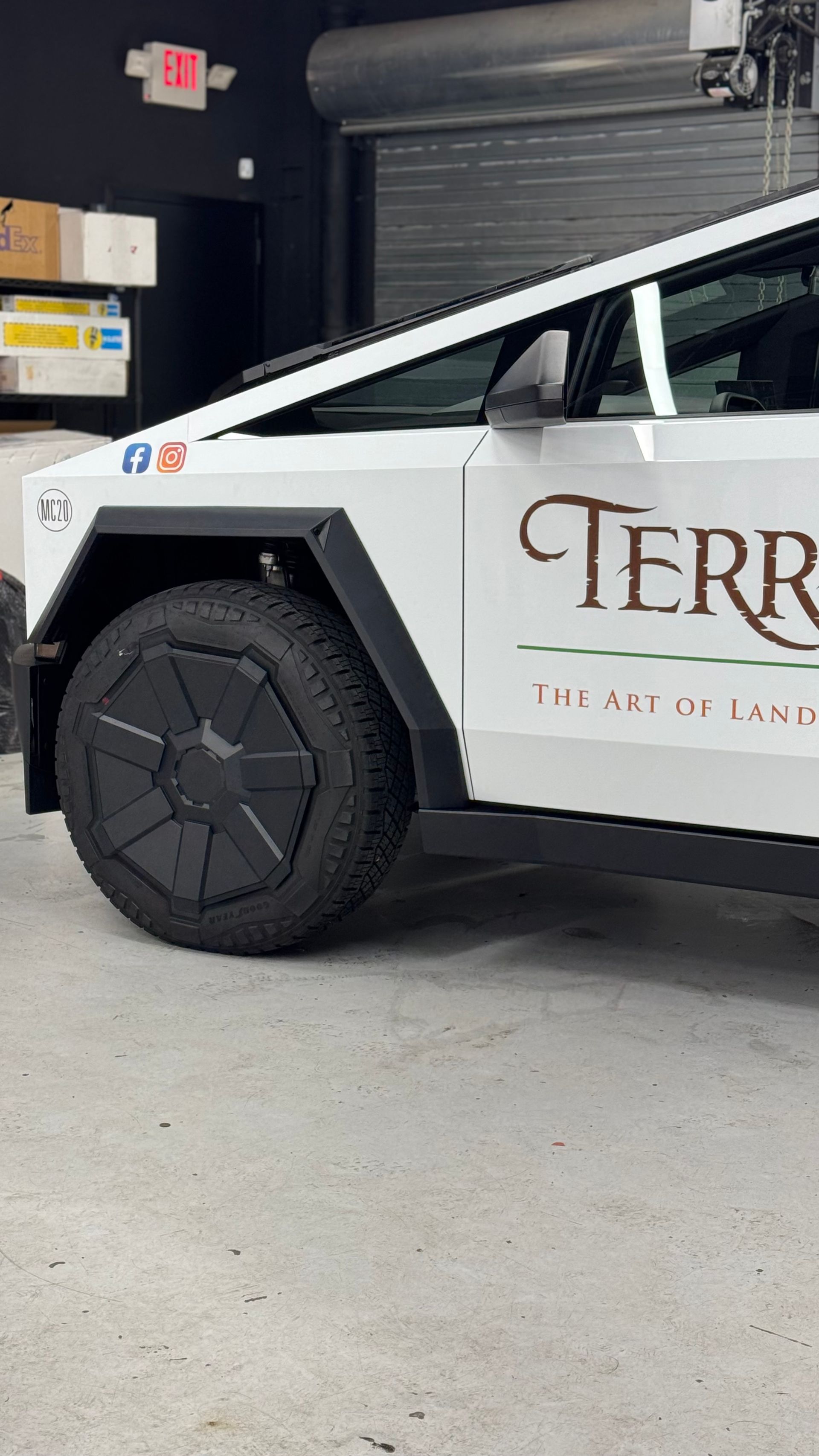 A white car with the word terra on the side is parked in a garage.