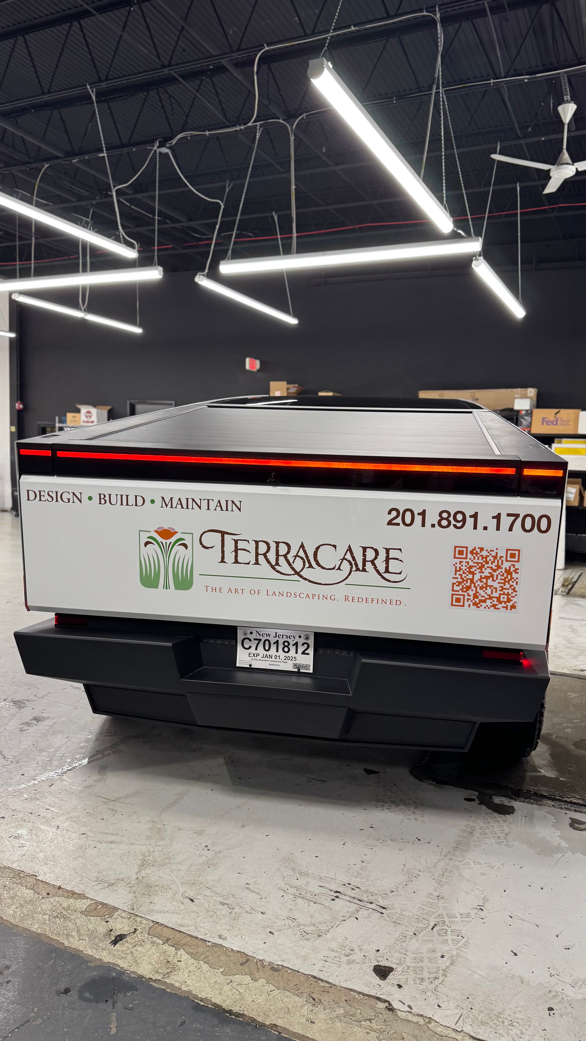 A truck is parked in a garage with a sticker on the back that says terracare.