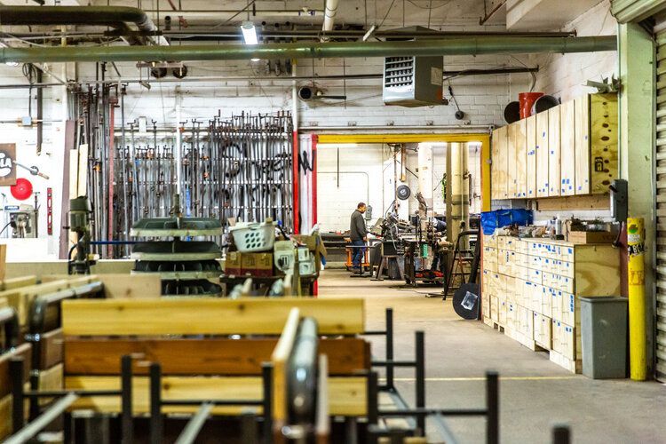 A warehouse filled with lots of wooden pieces and tools.