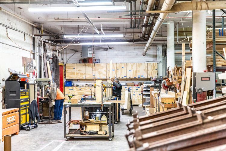 A large warehouse filled with lots of wood and tools.