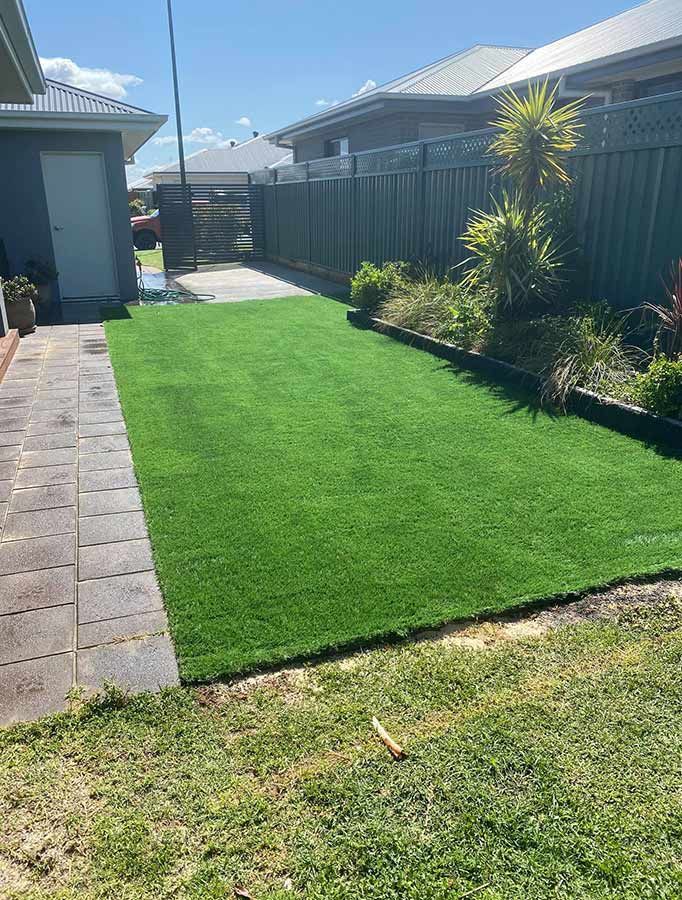 A Lush Green Lawn in Front of a House With a Fence — B & C Yard Improvements in Mudgee, NSW