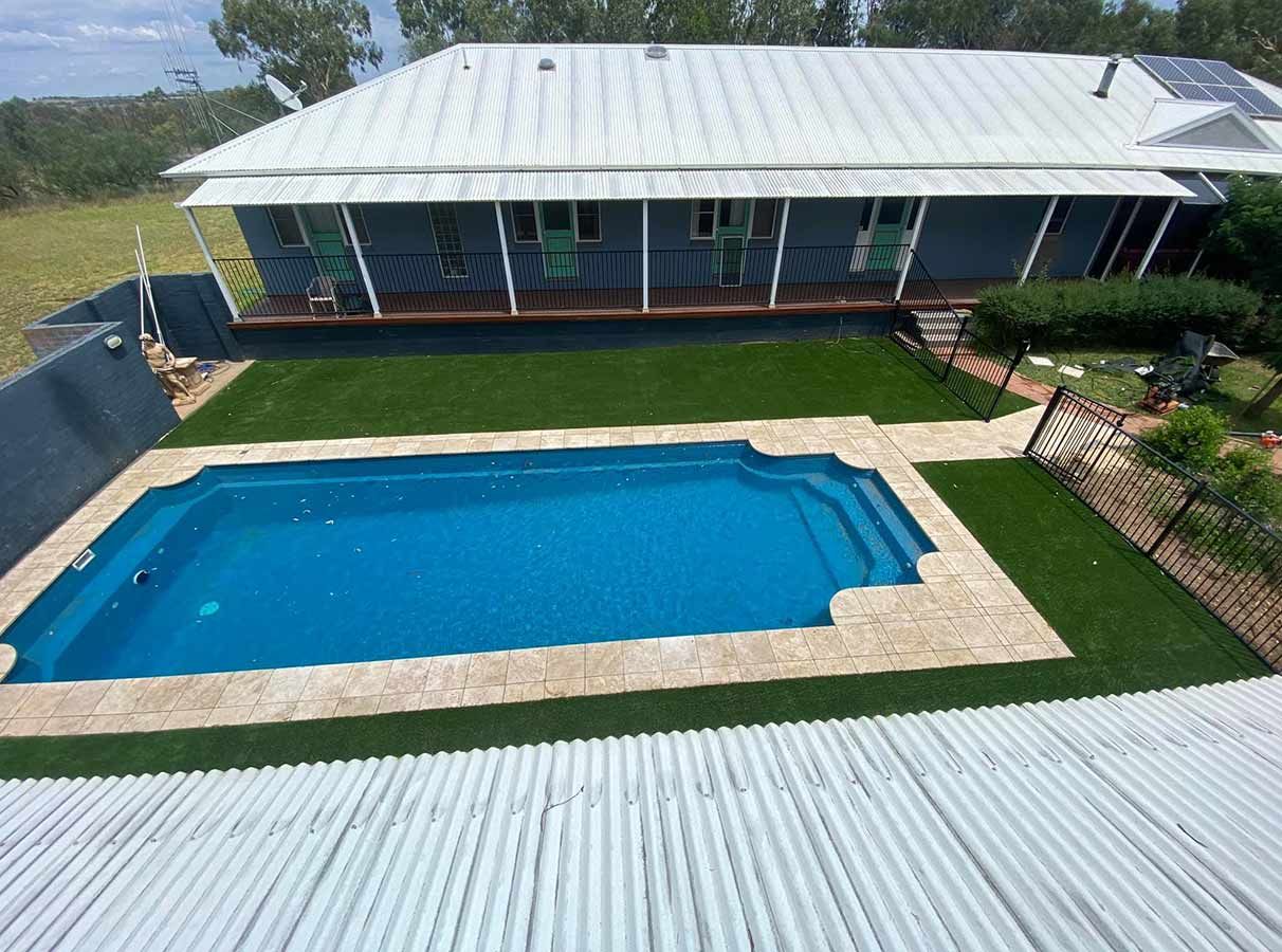 An Aerial View of a House With a Large Swimming Pool in Front of It — B & C Yard Improvements in Naroomine, NSW