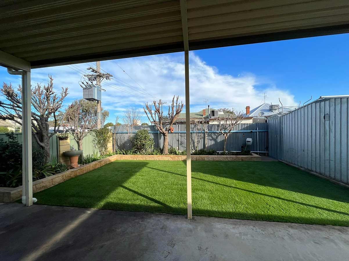 A Backyard With a Covered Area and a Lush Green Lawn — B & C Yard Improvements in Parkes, NSW