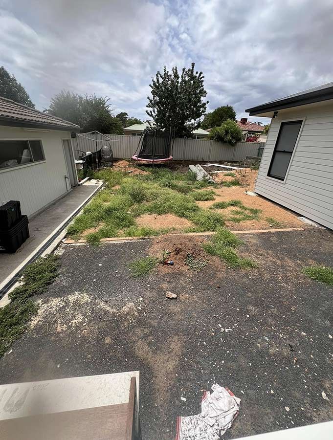 A Backyard With a Lot of Grass and a House in the Background — B & C Yard Improvements in Naroomine, NSW