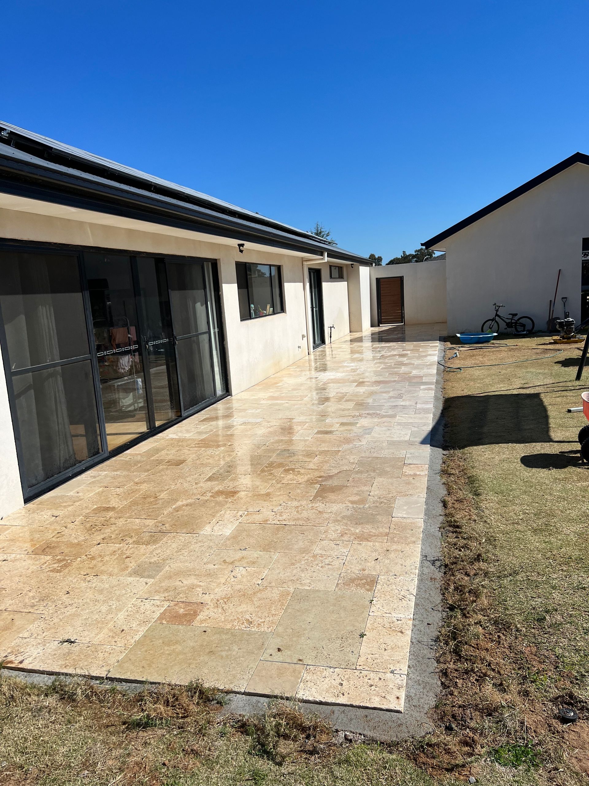 A Large Swimming Pool is Surrounded by a Fence in a Backyard — B & C Yard Improvements in Dubbo, NSW