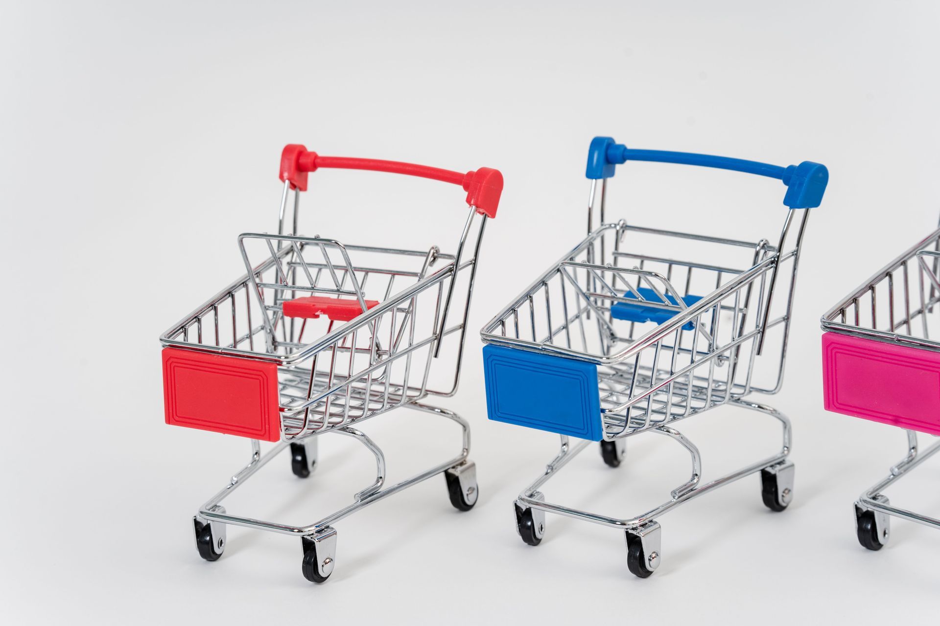 three colorful mini shopping carts