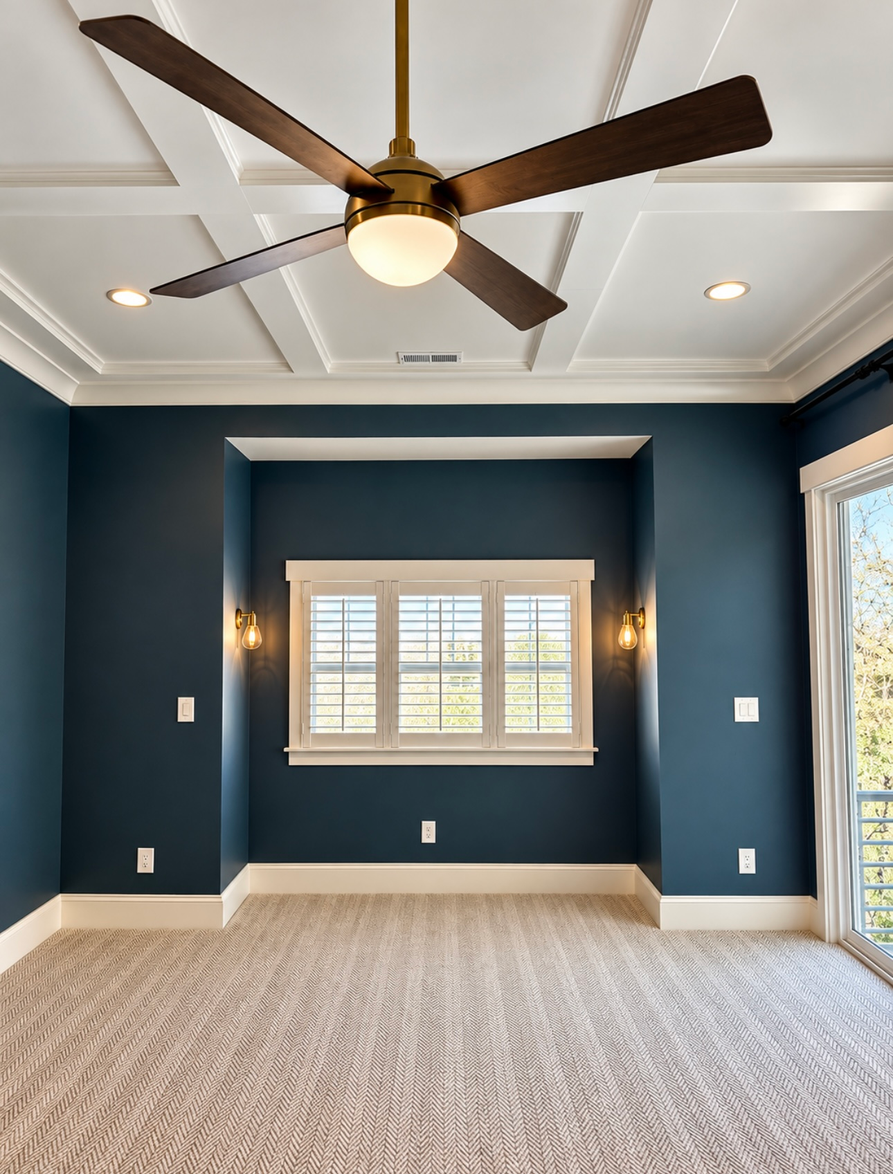 Empty navy-blue bedroom with tray ceiling, ceiling fan, window, and carpeted floor