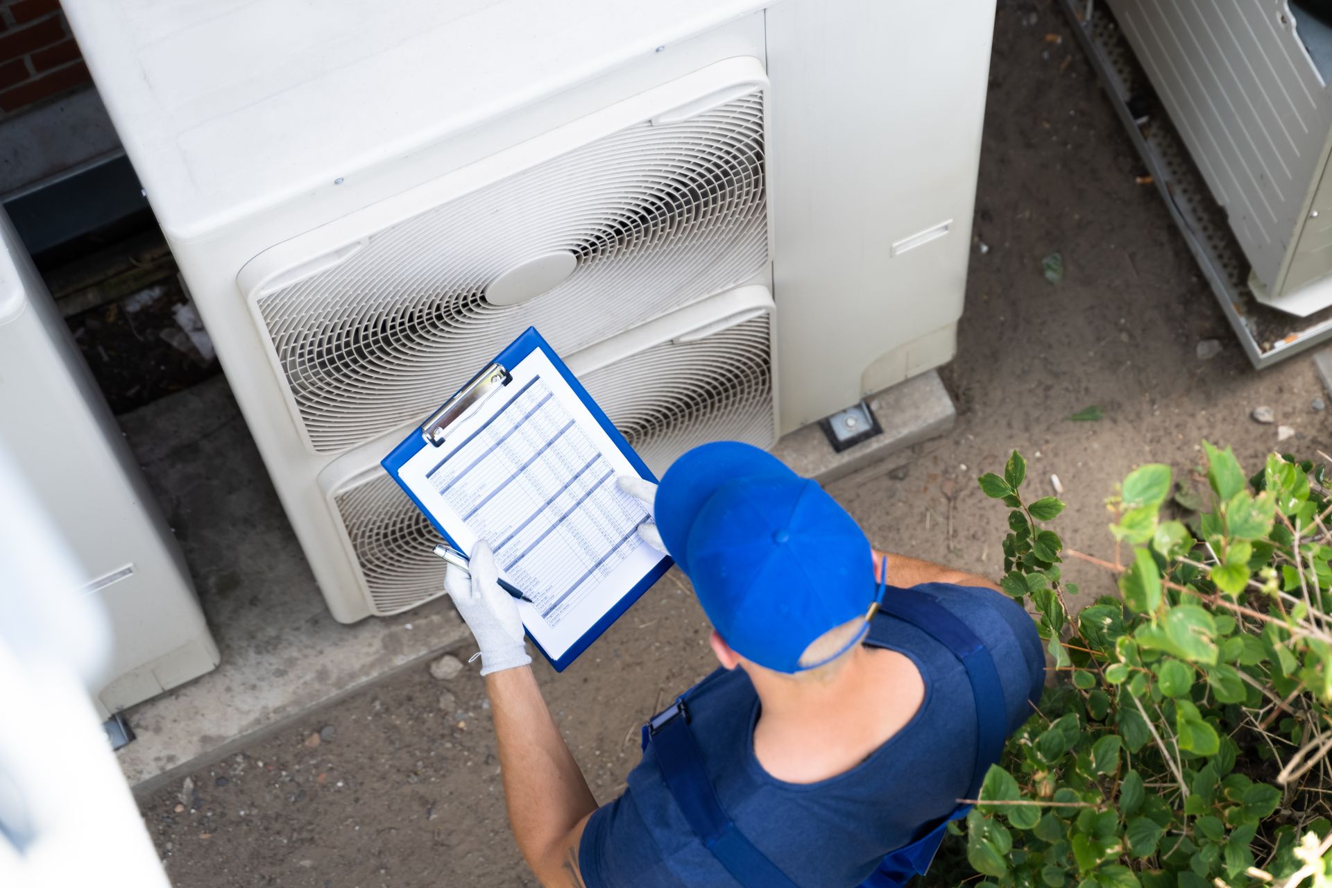 Man Checking the Outdoor Air Conditioner