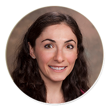 Smiling woman with dark hair against a neutral background