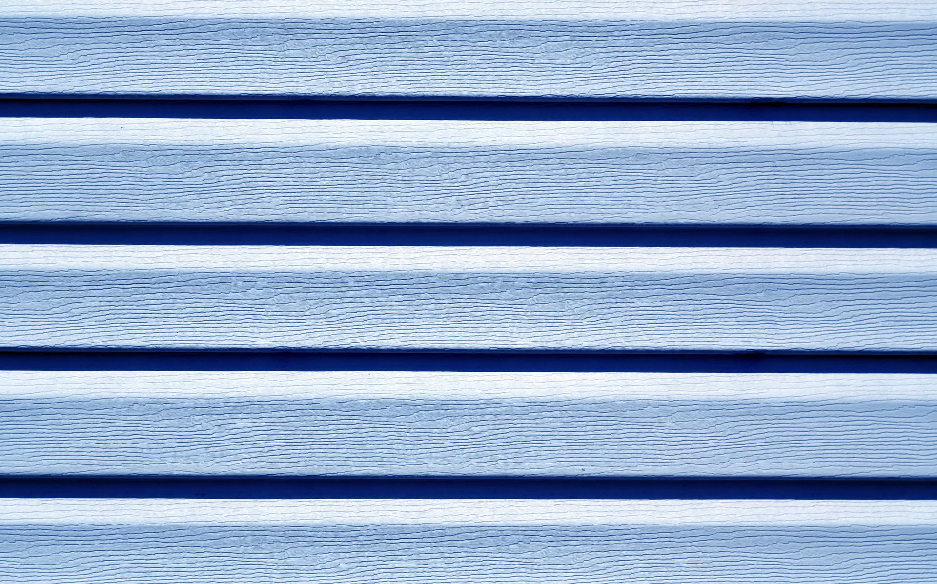 Blue ocean waves with dark horizontal bars across the image