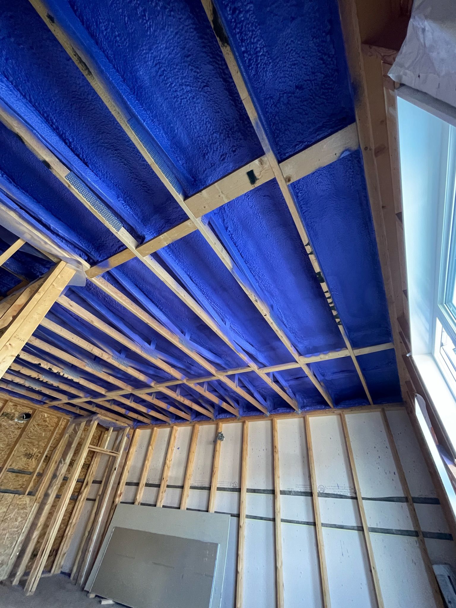 A room with a blue ceiling and wooden beams.