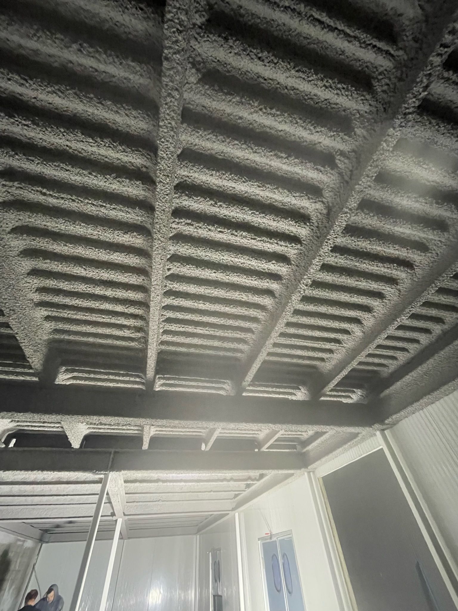 A black and white photo of the ceiling of a building.