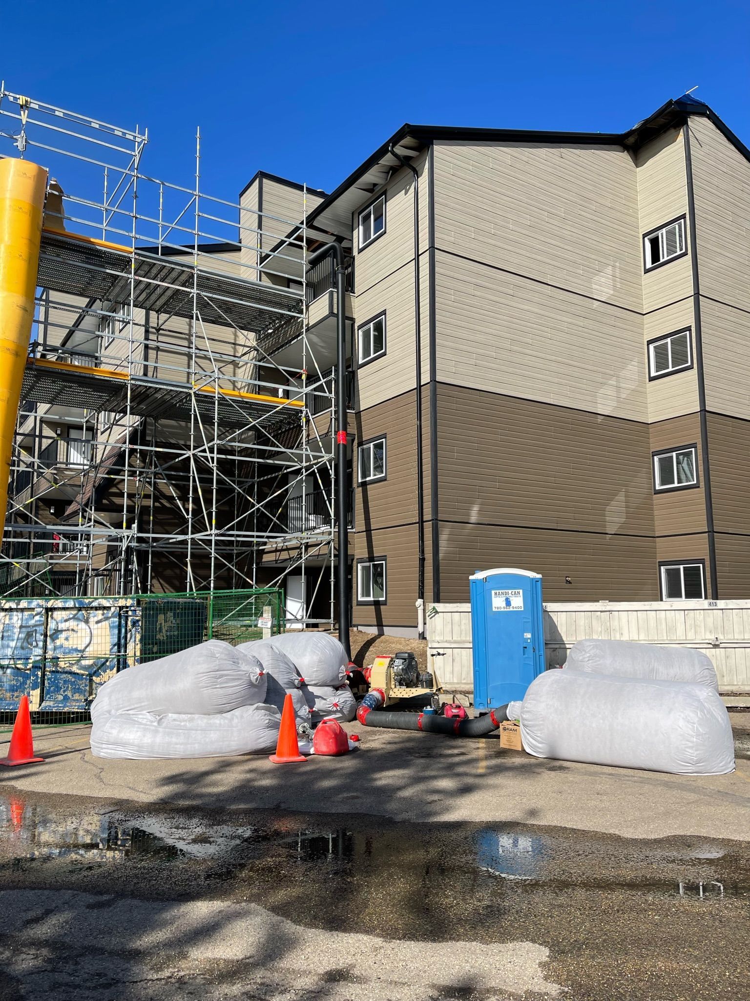 A construction site with a large building in the background