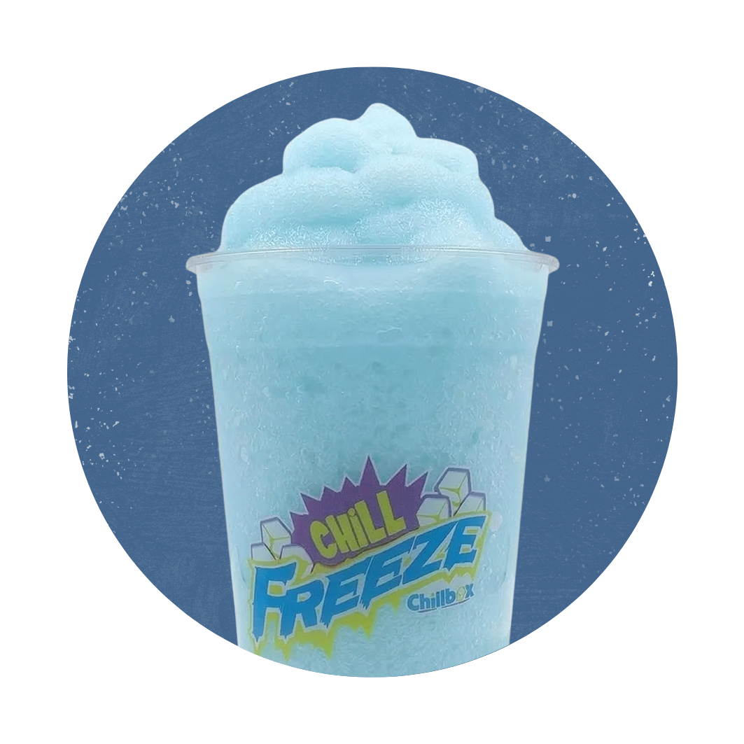 Blue frozen drink in a clear cup with a straw, topped with fluffy ice, against a blue background