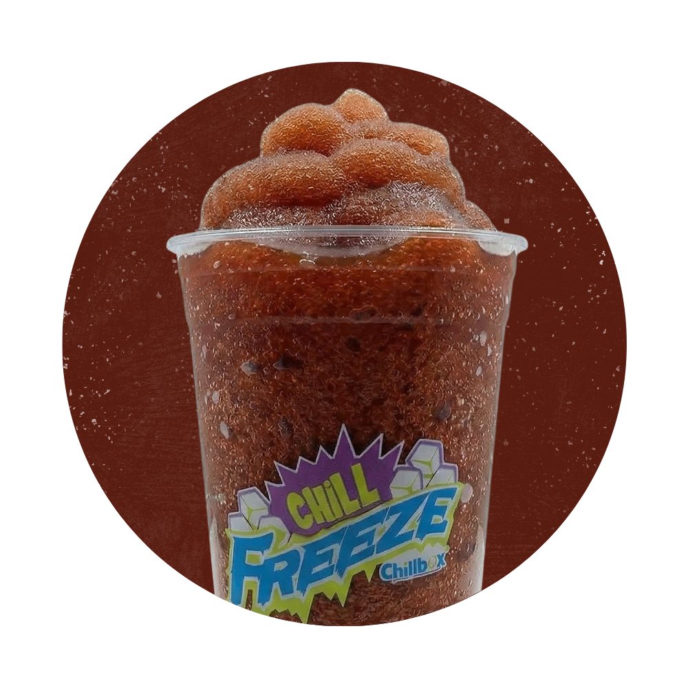 Frozen red Slurpee in a clear cup with a blue-and-yellow Chill Freeze label on a brown background