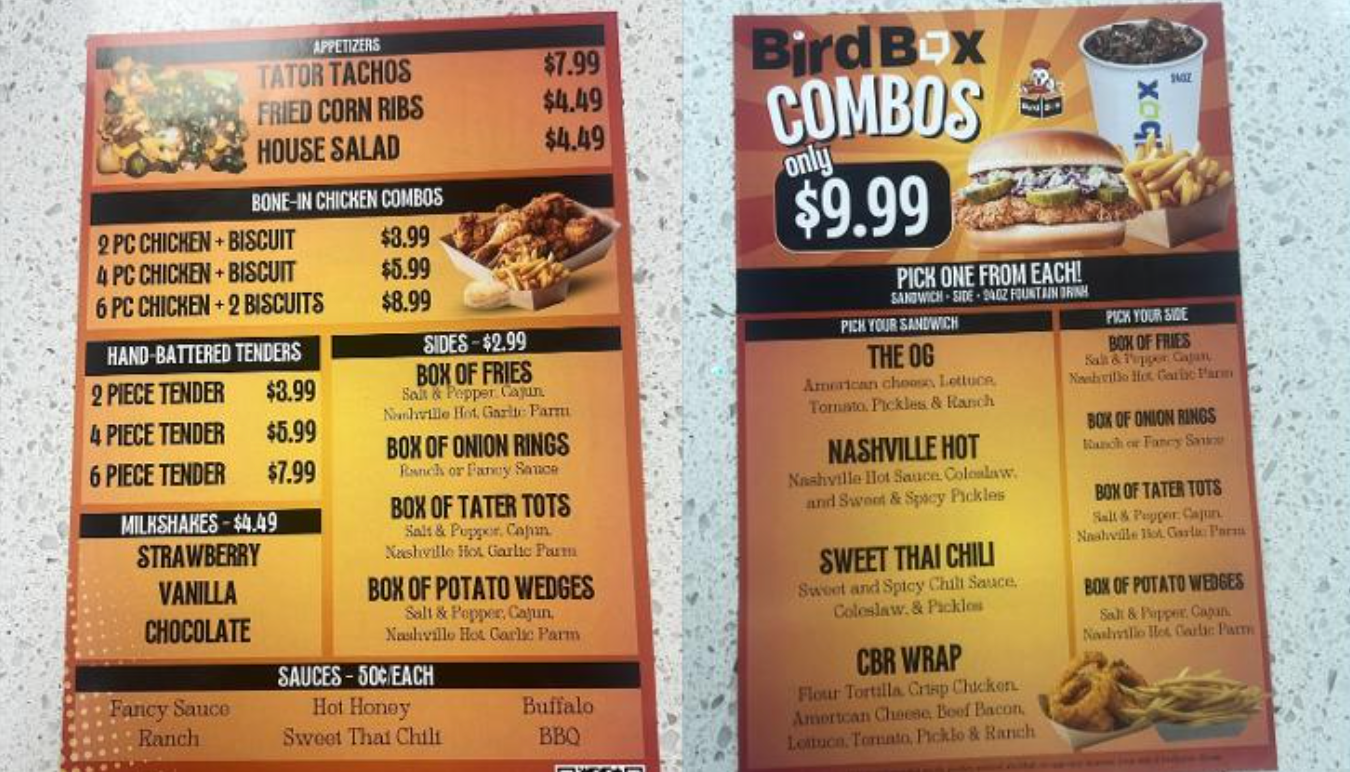Menu boards with bird box combos and fried chicken items, in orange and black.