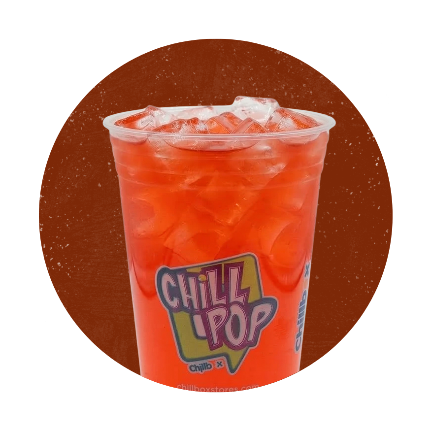 Red Chill Pop slush drink in a clear cup with ice on an orange background