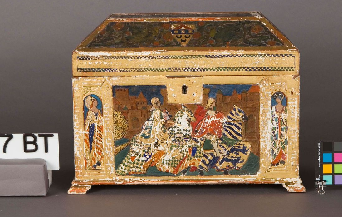 An antique wooden chest with painted courtly figures, standing on small feet against a grey background.