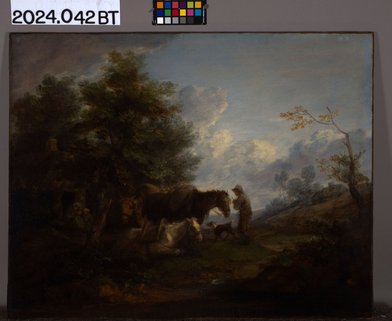 An oil painting shows a figure tending to horses in a lush, cloudy landscape with tall trees.