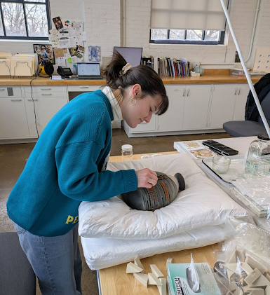 Assistant Objects Conservator Lydia Wood treating a vessel by Acquaetta Williams for the Chazen Art Museum.