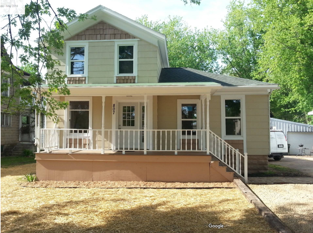 A house with a porch and stairs leading up to it