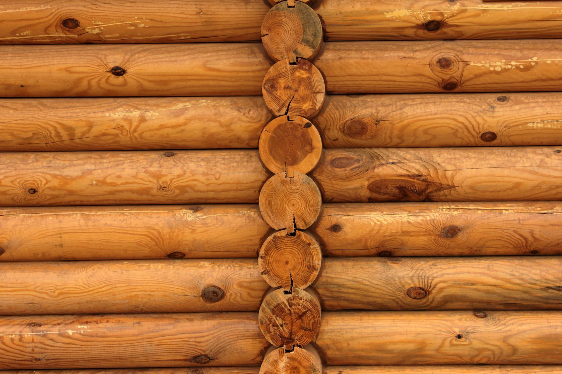 A close up of a wooden wall made of logs.