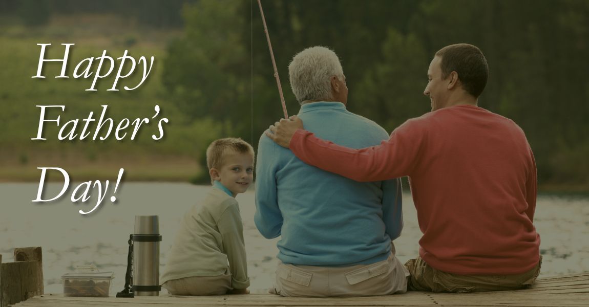 Happy Father’s Day! Three people sit together on a dock by the water.